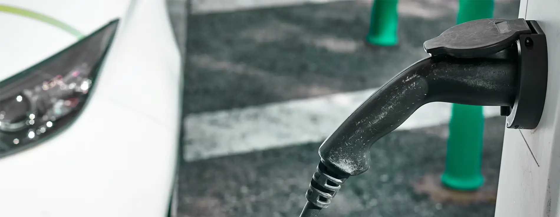 Close-up of an electric vehicle charging connector plugged into a station, with text overlay reading ‘Motion Applied launches AMPEX Ultra-Rapid EV Charging solutions to transform UK infrastructure.’ AMPEX logo appears in the bottom right corner.