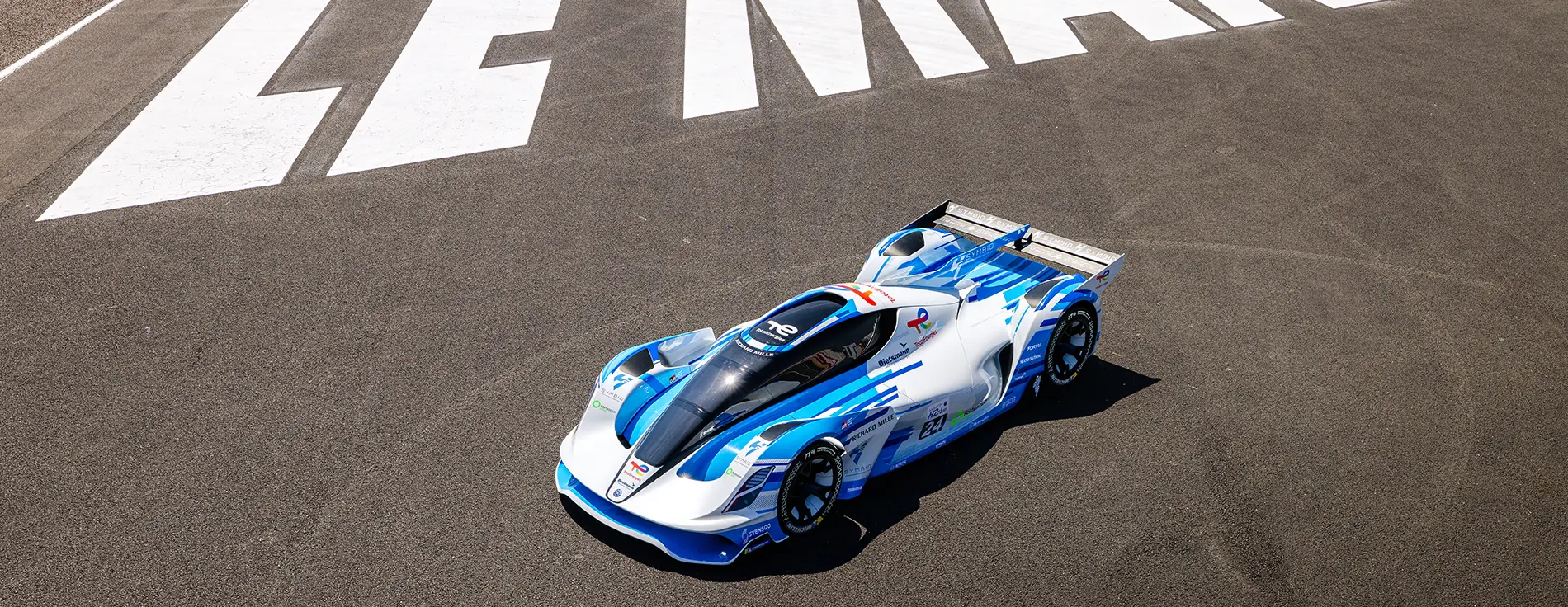 Blue hypercar on a racetrack